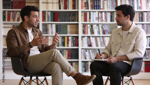 Two men in discussion at library
