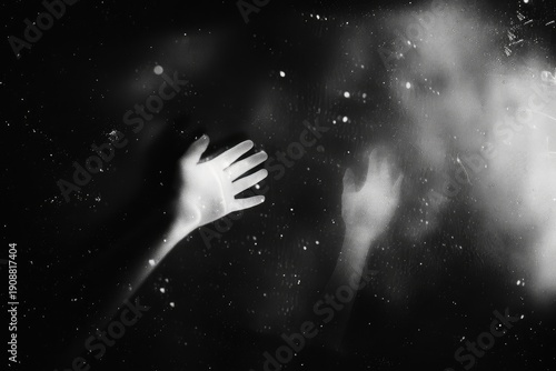 Hands reaching towards light; stars and shadows in background, for cosmic concepts