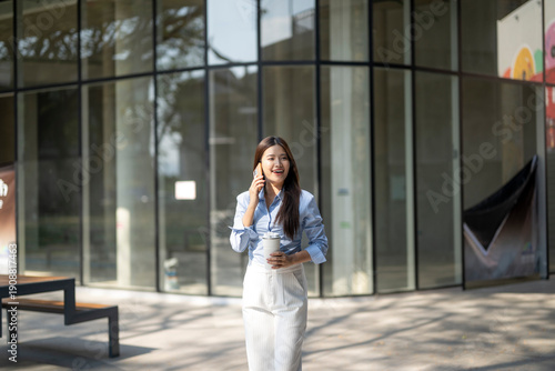 Free Download Professional woman walking and talking on smartphone - GFXLoad