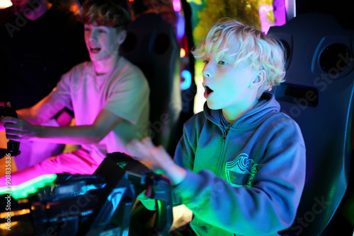 Kids Playing Shooting Video Game in Neon Light Arcade
