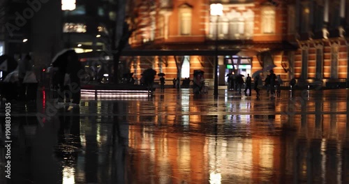 A night cityscape of the rainy urban street at the business town in Tokyo