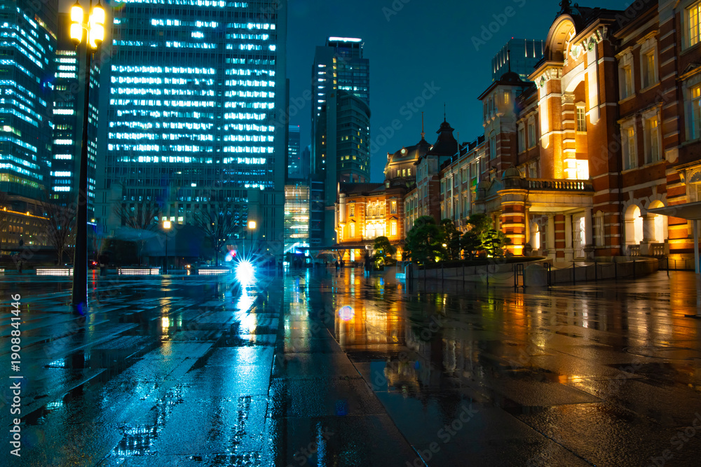 Naklejka premium A night cityscape of the rainy urban street at the business town in Tokyo