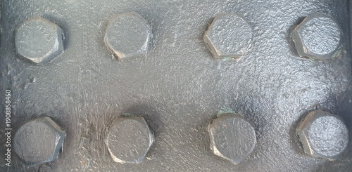 Industrial grey metal surface featuring heavy-duty hexagonal bolts. Detailed painted steel texture representing construction, engineering, strength, and architectural foundations