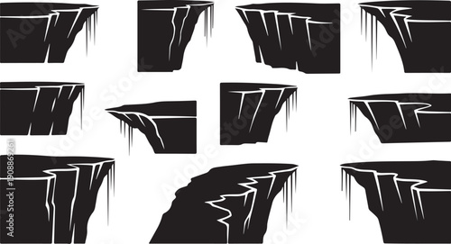 Collection of black cliff edges with white cracks and icicles