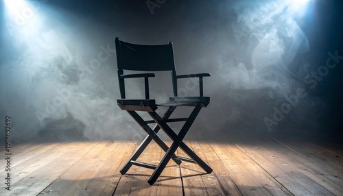 Empty director's chair on stage, spotlighted in atmospheric smoke