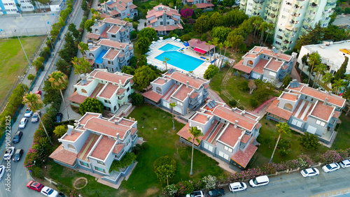Wallpaper Mural Mersin, Turkey. Top down drone view of small residential houses with lawns, street with parked cars and swimming pool in Mezitli district.. Aerial View Torontodigital.ca