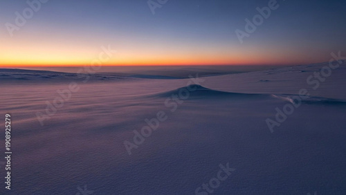 Wallpaper Mural Serene arctic sunrise illuminating pristine snowdrifts with a captivating interplay of warm and cool hues, showcasing the silent majesty of a winter wilderness Torontodigital.ca