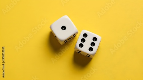 Two white dice with black dots on a bright yellow background