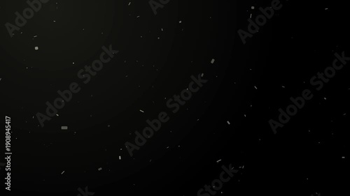 Abstract slow motion dust particles floating and drifting in light on a dark black background