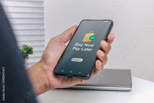 Obraz na plátně A man using smartphone for online shopping with payment later
