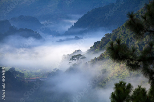 misty morning in mountain landscape with clouds