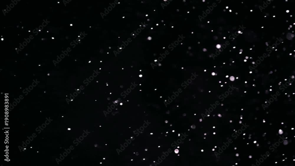 Cinematic white particles floating in dark space with soft bokeh and ...