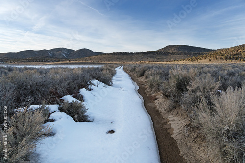 Partially Snow Covered Doubletrack Dirt Road In The Inyo Mountains