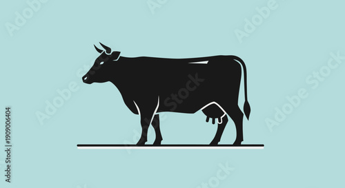 Black cow silhouette standing alone.