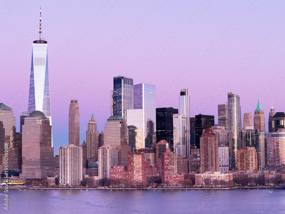 Fototapeta premium New York City at dusk. Manhattan skyscrapers at sunset. New York City panorama view. Manhattan panoramic skyscrapers at dusk. Manhattan skyline waterfront. New York City skyline.