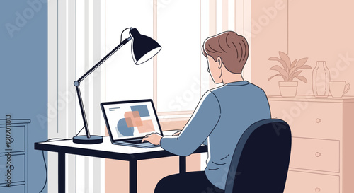 Young professional working diligently on laptop in modern home office