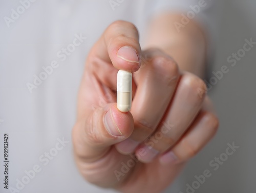 Hand Holding Medical Capsule Pill Supplement Health Treatment