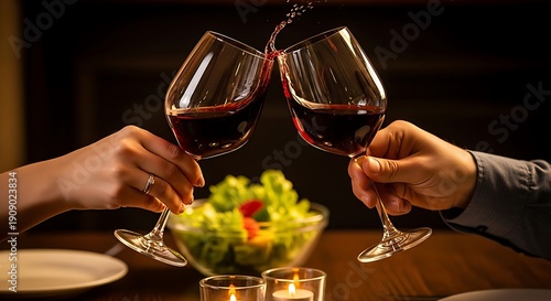 Wallpaper Mural Two people clinking wine glasses in a cozy dining setting with a plate of fresh greens. Torontodigital.ca