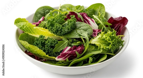 A salad of various leafy greens fills a white bowl prominently featuring spinach lettuce kale and arugula
