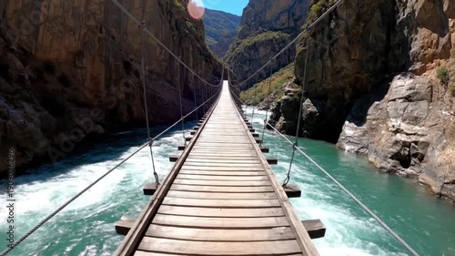 Long Wooden Suspension Bridge over Rushing River in Deep Canyon