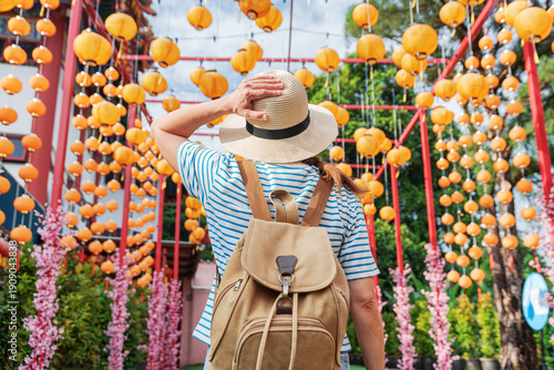 Wallpaper Mural Woman enjoying view of outdoor passage decorated with lanterns Torontodigital.ca