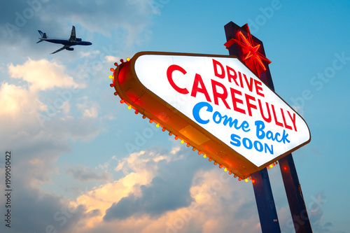 Drive Carefully Come Back Soon Sign, Welcome to Fabulous Las Vegas Sign. Logo Removed. The beautiful sunset sky in the background.