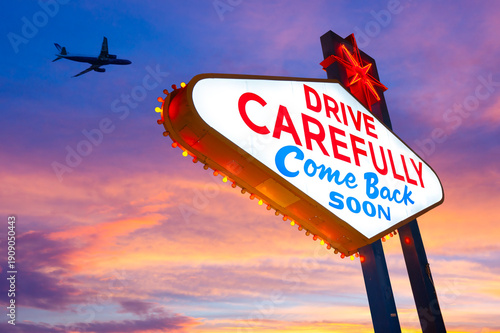 Drive Carefully Come Back Soon Sign, Welcome to Fabulous Las Vegas Sign. Logo Removed. The beautiful sunset sky in the background.