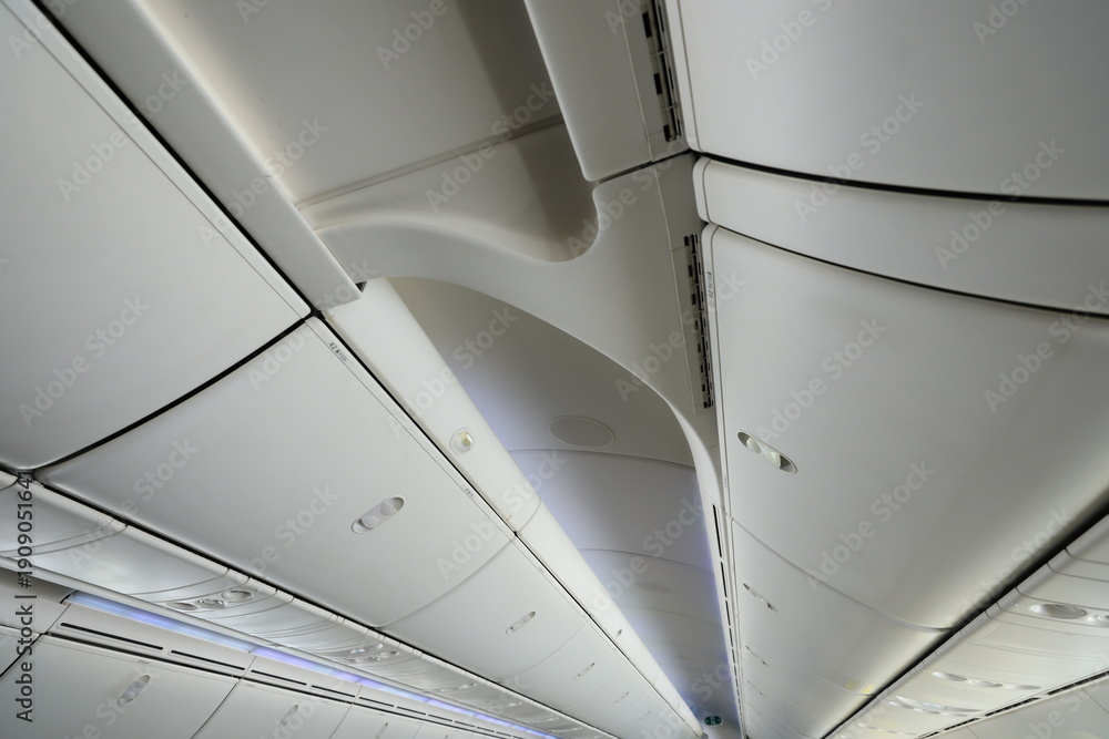 Fototapeta premium Airplane cabin ceiling and overhead bins.