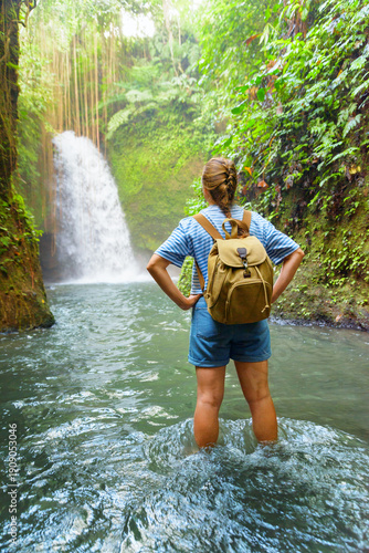 Wallpaper Mural Female tourist with backpack enjoying view of awesome waterfall Torontodigital.ca