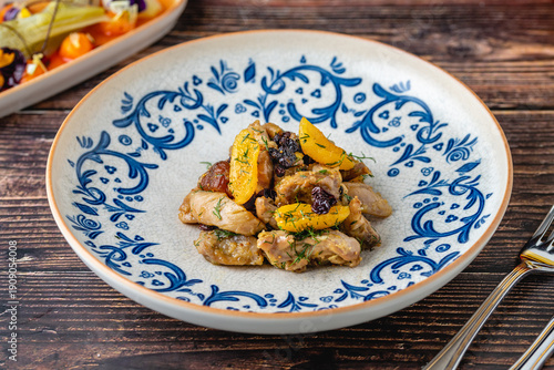 Wallpaper Mural Chicken dish with dried fruits served in traditional patterned plate Torontodigital.ca