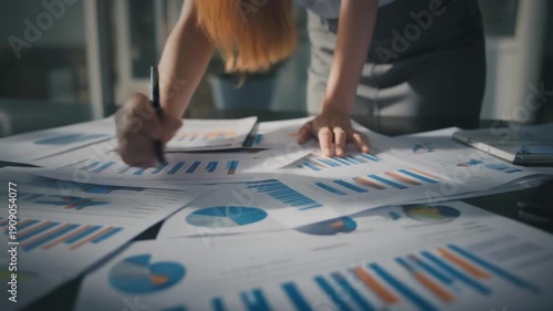 Wallpaper Mural Close Up Of Hands Reviewing Financial Charts And Graphs On Paper Spread Out On A Desk business Torontodigital.ca