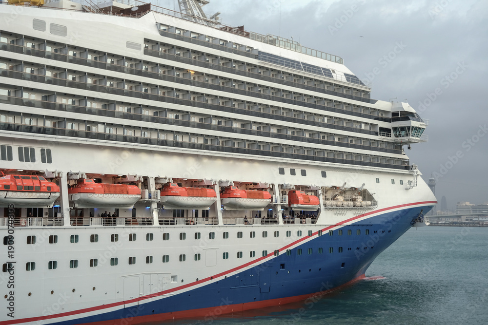 Obraz premium Modern cruiseship or cruise ship liner Freedom arrival into port of Barcelona Espana, Spain gateway in summer during Mediterranean cruising