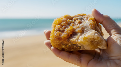 Wallpaper Mural Hand holding a large chunk of raw ambergris. perfume ingredient concept. Torontodigital.ca