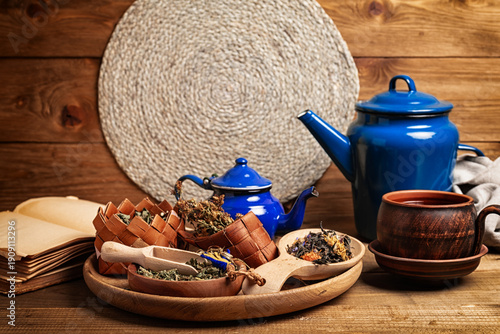 cup of herbal tea and ingredients on wooden table