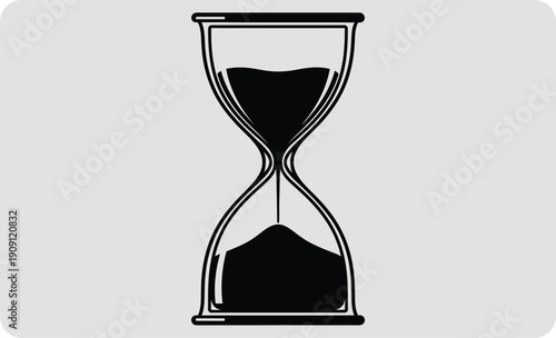 Hourglass with black sand on a gray background