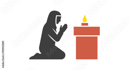 Muslim woman praying in front of candle on altar in subtle tones  