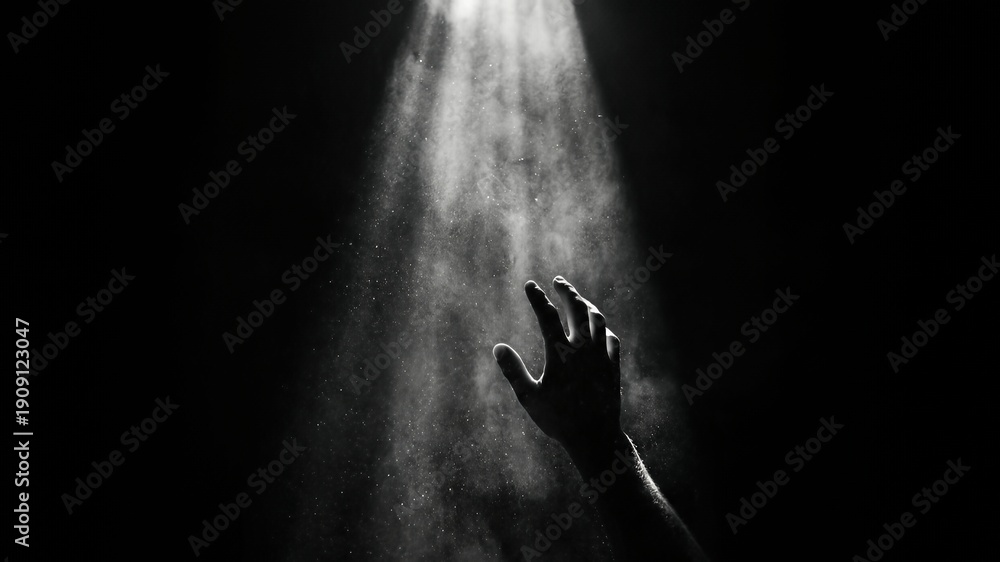 Obraz premium Ethereal Light Beam Illuminating a Reaching Hand in Dark Space with Soft Particles Effect