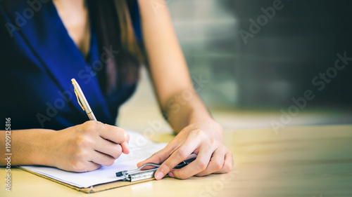 Hand of business woman or secretary take note on paperwork or sign contact while business meeting at office, business financial presentation conference concept