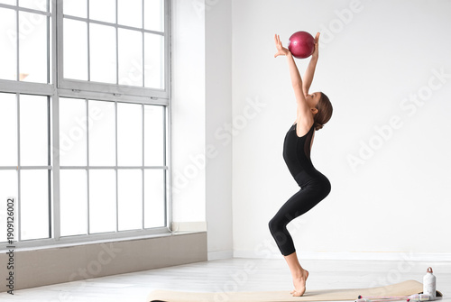 Cute girl with ball doing g...