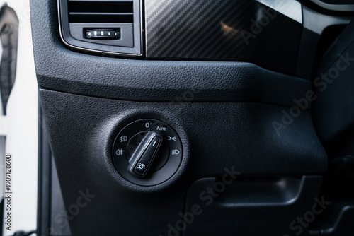 Modern interior of a family SUV, leather steering wheel, sports leather seats, large navigation screen. Interior details.