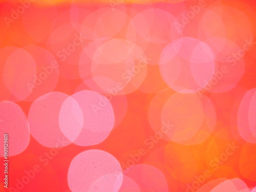 Abstract Bokeh from indoor lighting, Pink with red with orange with gold and yellow circles colored surface, Night city light background for celebration of christmas and holiday season