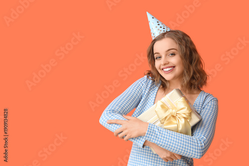 Young woman in party hat wi...