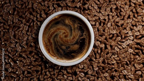 Top view of coffee cup and roasted beans.