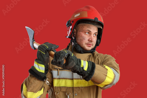 Male firefighter with axe o...