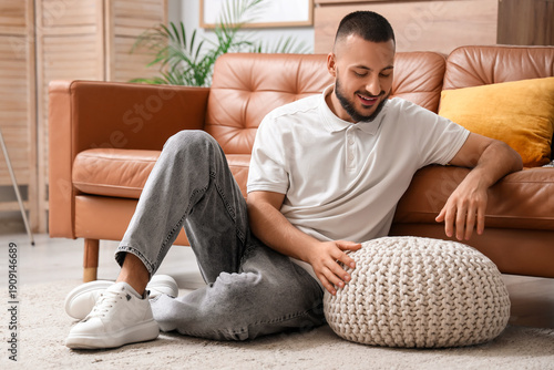 Young man with knitted pouf...