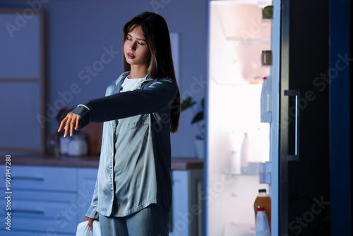 Photography Female sleepwalker near fridge in kitchen at night