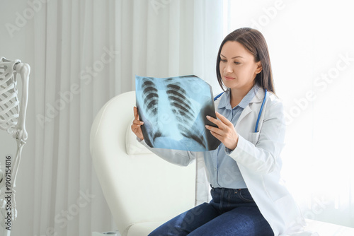 Female doctor studying x-ra...