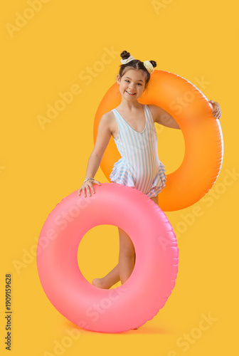 Cute girl with swim rings o...