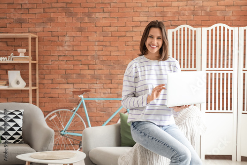 Young woman using laptop on...