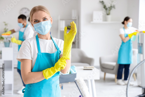 Female janitor with mask an...
